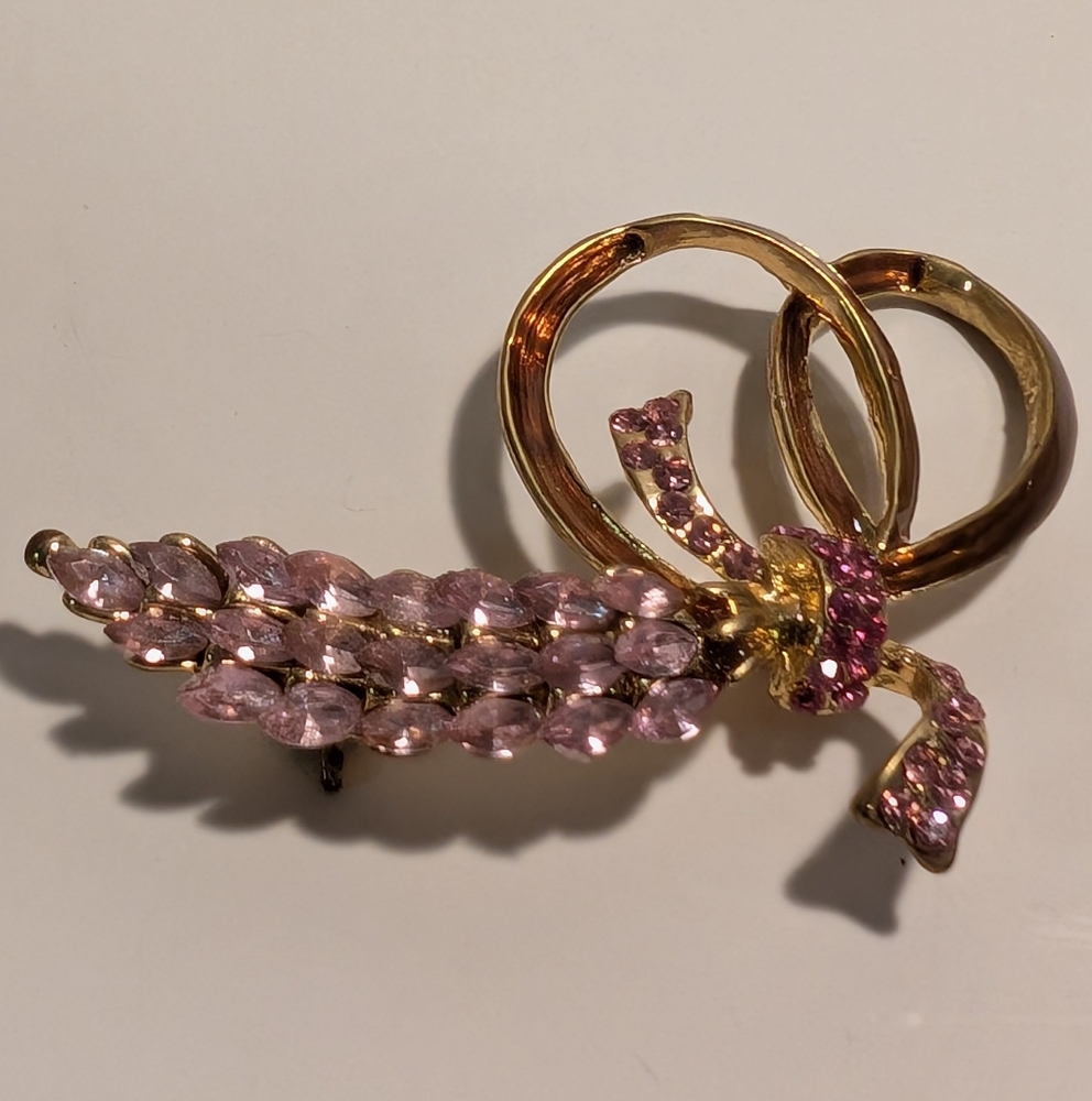 A vintage floral bow brooch with pink rhinestones. 